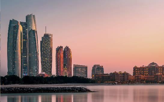 Abu Dhabi waterfront skyline at sunset
